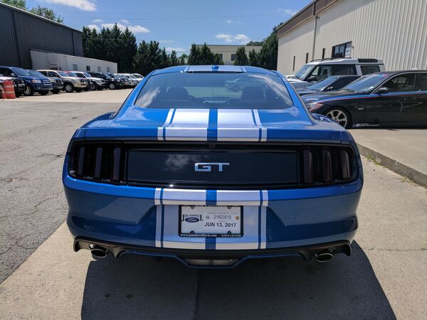 Blue Ford Mustang GT with racing stripes and tinted windows Philadelphia