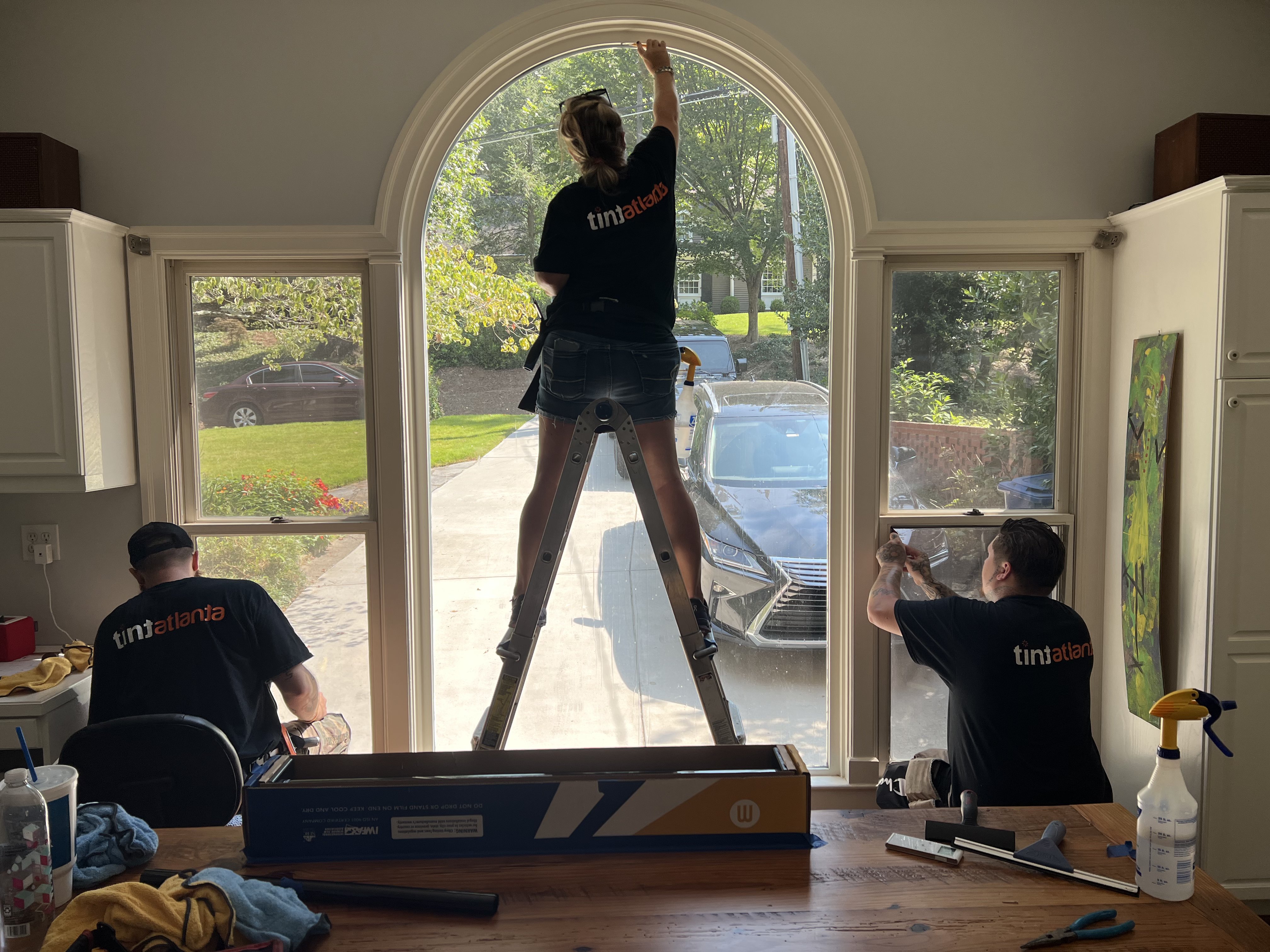 Tint Philadelphia team installing residential window film